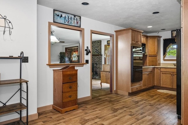 148 Walnut Hill Rd, Orange, MA 01364 - kitchen featuring light wood-type flooring, brown cabinets, light countertops, and recessed lighting