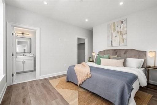 260 Elm St Unit 204, Everett, MA 02149 - bedroom featuring wood finished floors, recessed lighting, baseboards, and connected bathroom