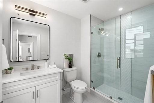 260 Elm St Unit 204, Everett, MA 02149 - bathroom featuring vanity, toilet, a stall shower, and recessed lighting