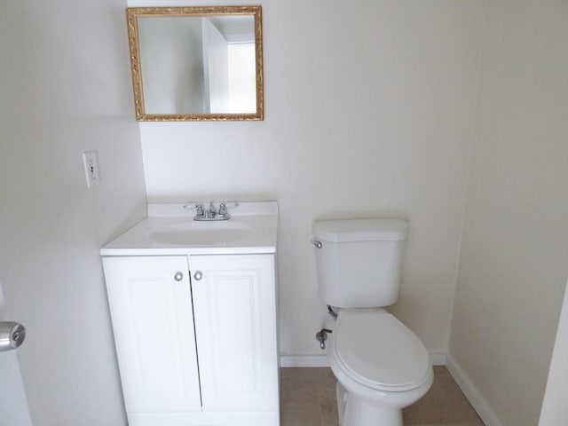 bathroom featuring toilet, tile patterned flooring, and vanity