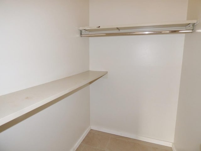 spacious closet with light tile patterned flooring