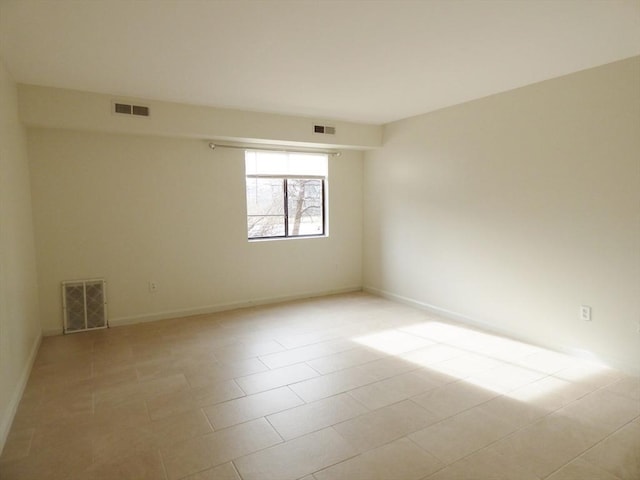 spare room featuring light tile patterned floors