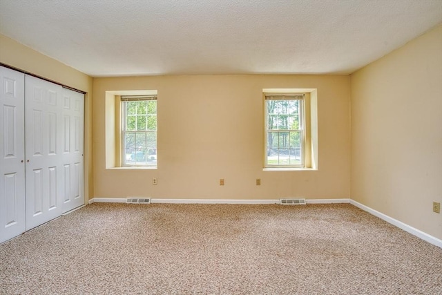 141 Shaw Farm Rd Unit 141, Canton, MA 02021 - unfurnished bedroom featuring multiple windows, carpet floors, and baseboards