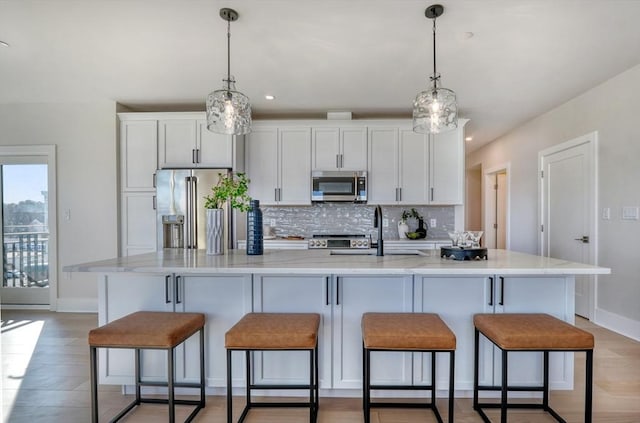 62 Foundry St Unit 215, Wakefield, MA 01880 - kitchen with stainless steel appliances, backsplash, white cabinets, a large island, and recessed lighting