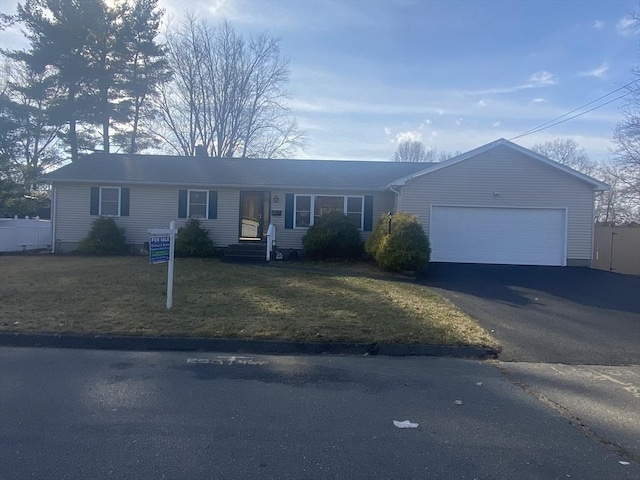 single story home with a garage and a front lawn