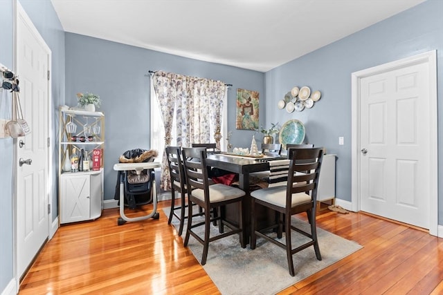 dining space with hardwood / wood-style floors