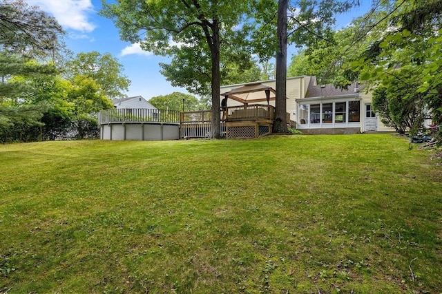 83 Summit Rd, Abington, MA 02351 - view of grassy yard featuring a sunroom, a wooden deck, and an outdoor pool