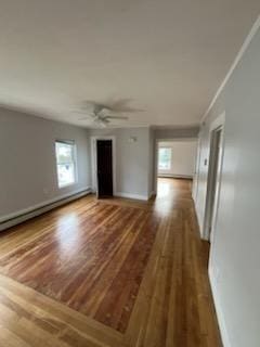 10 Stevens St, Lawrence, MA 01843 - unfurnished living room with wood finished floors, a baseboard radiator, and baseboards