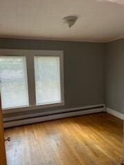 10 Stevens St, Lawrence, MA 01843 - unfurnished room featuring baseboard heating, wood finished floors, and baseboards
