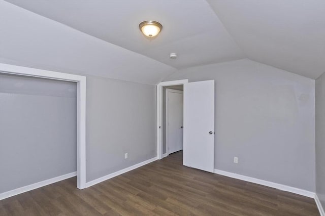 additional living space with wood finished floors, lofted ceiling, and baseboards