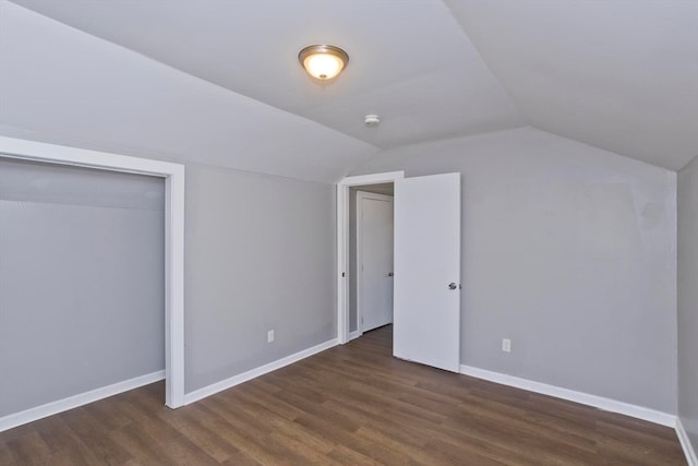 additional living space featuring lofted ceiling and dark hardwood / wood-style flooring