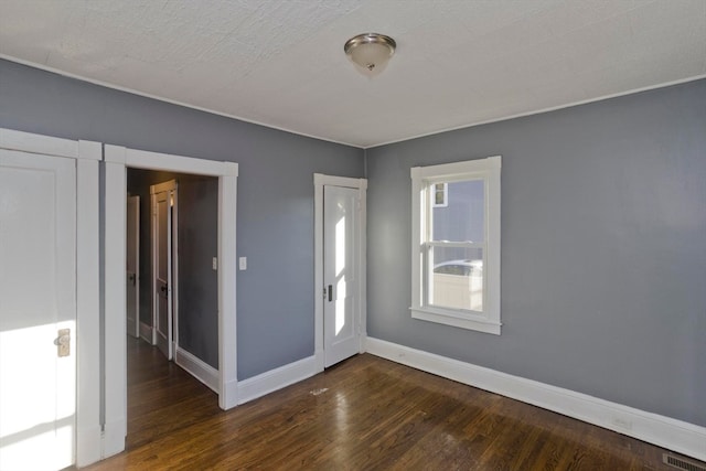 unfurnished room featuring dark hardwood / wood-style flooring