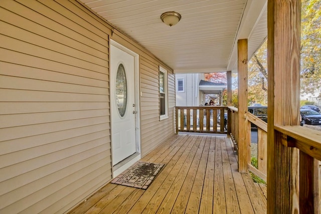 wooden terrace featuring covered porch