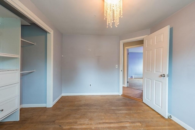3 Sears Ave, Webster, MA 01570 - unfurnished bedroom featuring a chandelier, light wood-type flooring, baseboard heating, and a closet