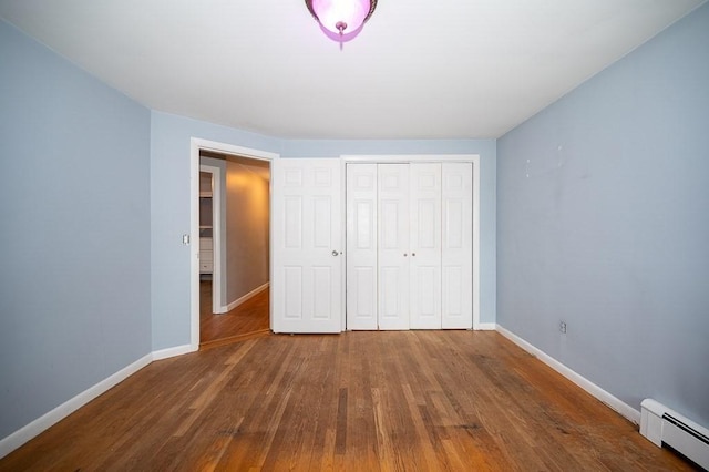 3 Sears Ave, Webster, MA 01570 - unfurnished bedroom featuring a baseboard heating unit, wood finished floors, and a closet