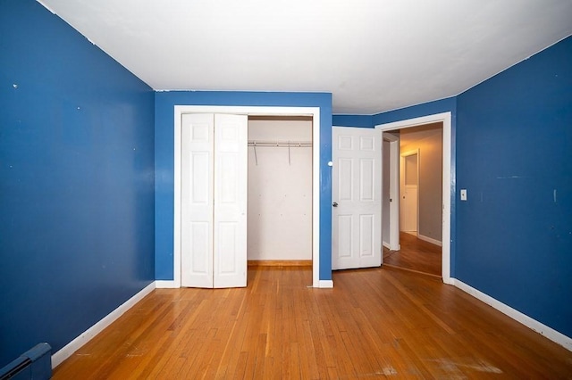 3 Sears Ave, Webster, MA 01570 - unfurnished bedroom featuring hardwood / wood-style flooring, baseboard heating, and a closet