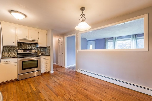 3 Sears Ave, Webster, MA 01570 - kitchen featuring stainless steel electric range, a baseboard heating unit, under cabinet range hood, dark countertops, and tasteful backsplash