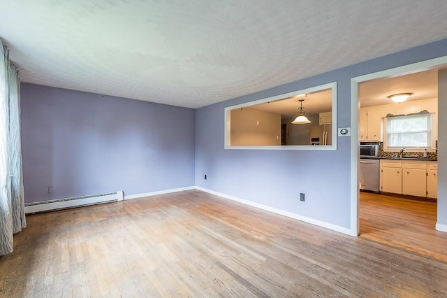 3 Sears Ave, Webster, MA 01570 - unfurnished living room featuring baseboard heating and wood finished floors