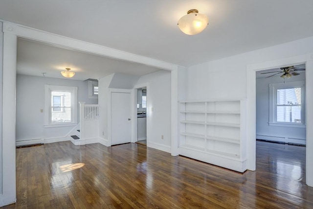 unfurnished living room with dark hardwood / wood-style floors, baseboard heating, and ceiling fan