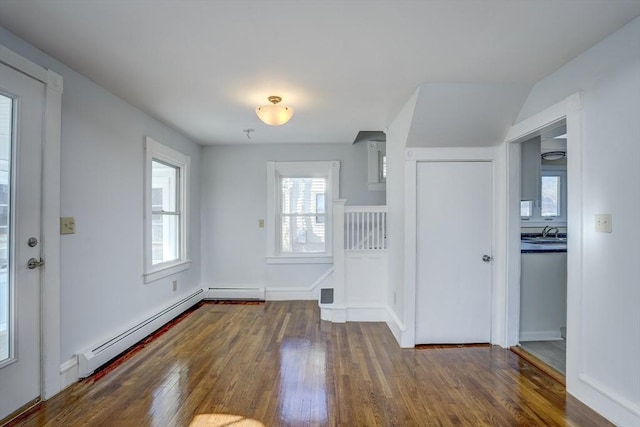 entrance foyer with dark hardwood / wood-style flooring, a baseboard heating unit, and sink