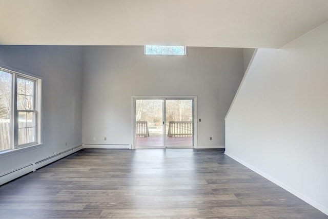 unfurnished living room featuring baseboard heating, a skylight, and wood-type flooring