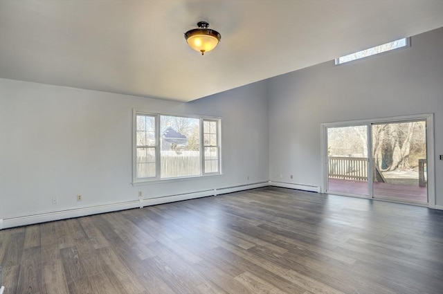 empty room featuring baseboard heating and hardwood / wood-style flooring