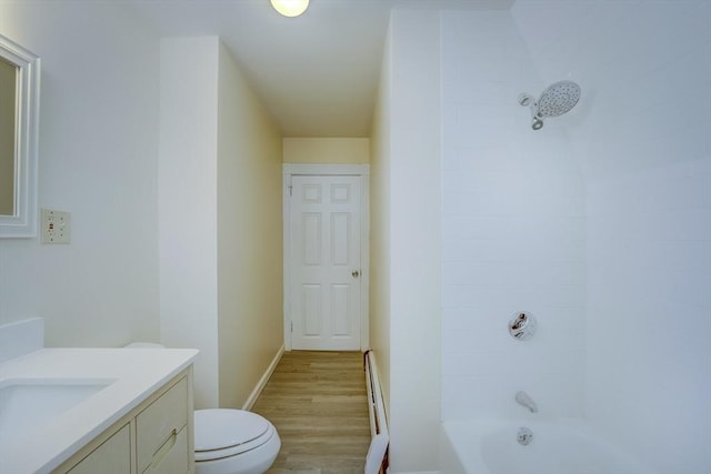 full bathroom featuring vanity, a baseboard heating unit, shower / washtub combination, hardwood / wood-style flooring, and toilet