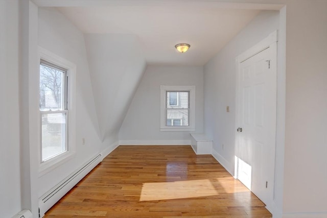 bonus room with baseboard heating and light hardwood / wood-style floors