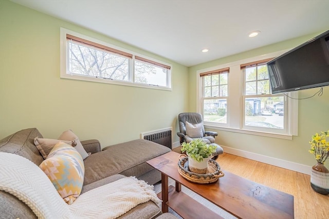 living room featuring baseboards, recessed lighting, and wood finished floors
