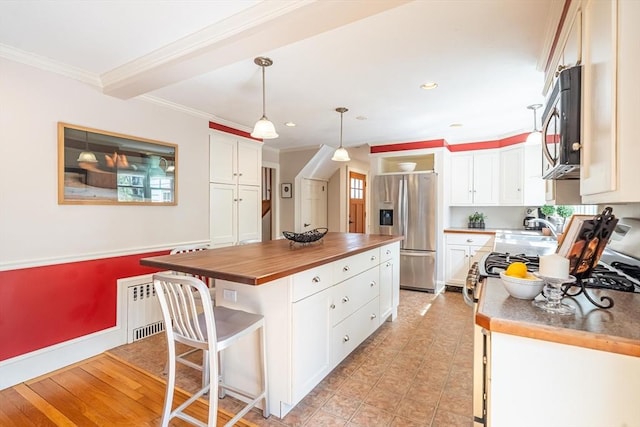 kitchen featuring crown molding, wood counters, stainless steel refrigerator with ice dispenser, and white cabinetry