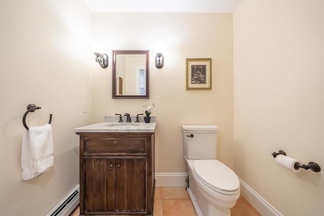 half bath featuring vanity, toilet, baseboards, tile patterned floors, and a baseboard heating unit