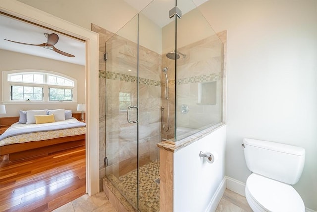 bathroom with connected bathroom, toilet, baseboards, and a stall shower