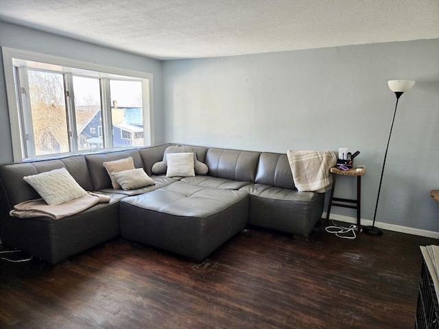 living room featuring dark hardwood / wood-style floors and a textured ceiling