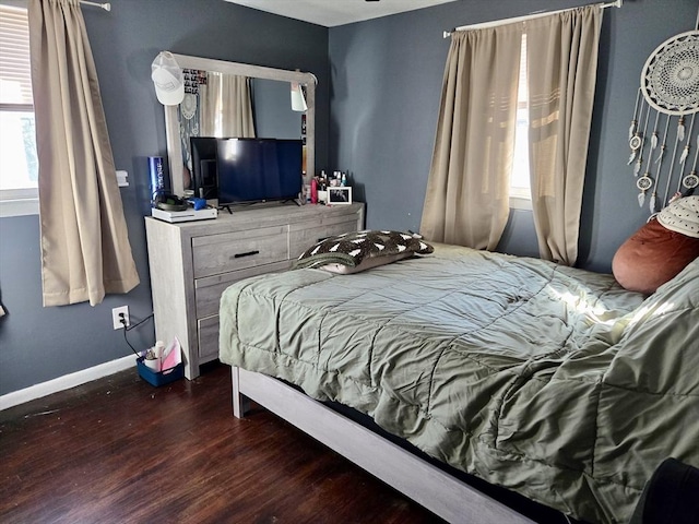 bedroom with dark hardwood / wood-style floors