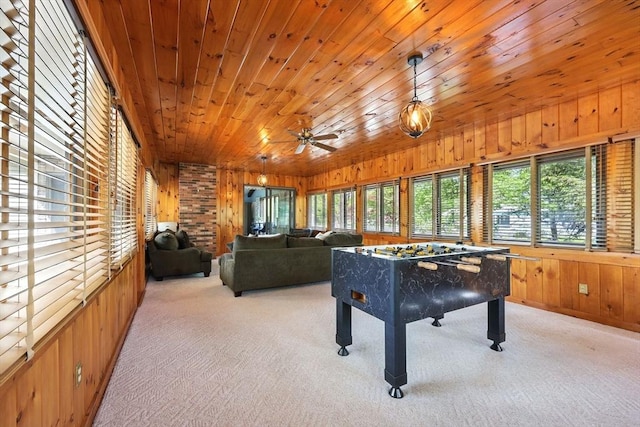 playroom with wood walls, carpet, a ceiling fan, and wooden ceiling