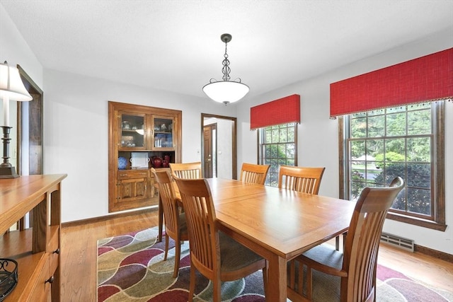 dining area featuring wood finished floors and baseboards