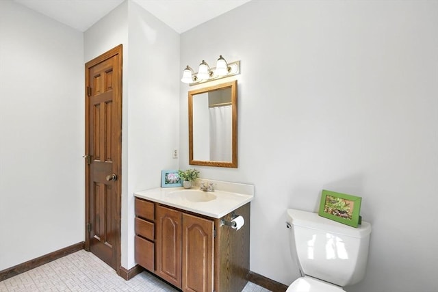 full bathroom with toilet, baseboards, and vanity