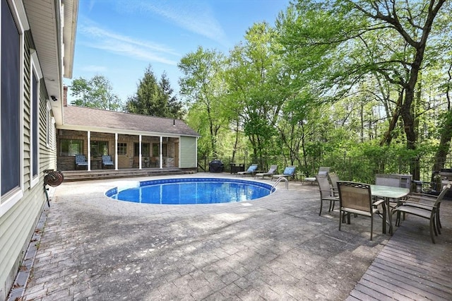 view of pool with a patio area and outdoor dining area