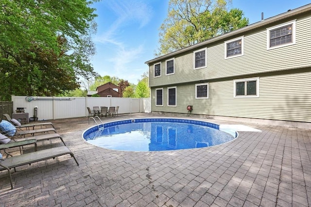 view of swimming pool with a patio and a fenced backyard