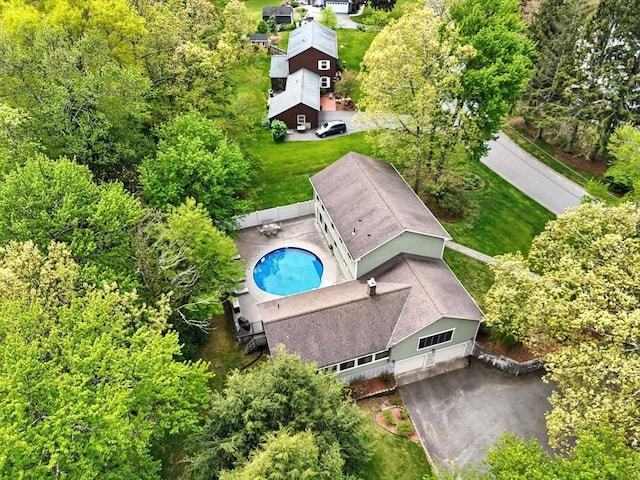 aerial view of property and surrounding area featuring a pool area
