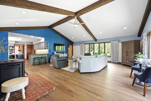 living room with light wood-type flooring, a ceiling fan, and recessed lighting