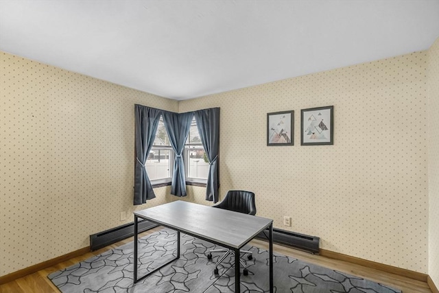 home office with wood finished floors, wallpapered walls, baseboard heating, baseboards, and a baseboard radiator