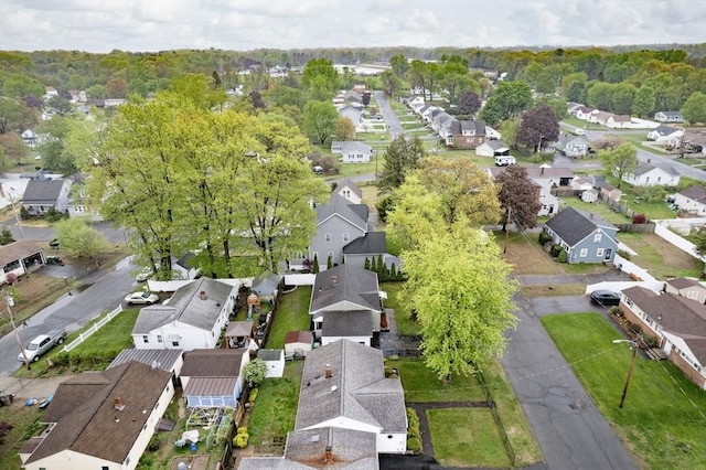 aerial view of property and surrounding area featuring nearby suburban area