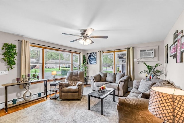 living room featuring healthy amount of natural light, a wall mounted AC, ceiling fan, and wood finished floors