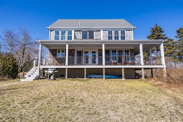 back of property featuring a yard and stairway