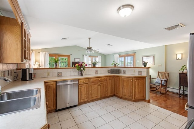kitchen with stainless steel dishwasher, a sink, light countertops, lofted ceiling, and a ceiling fan