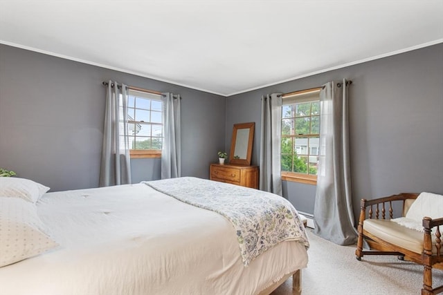 bedroom with carpet floors, crown molding, and a baseboard radiator