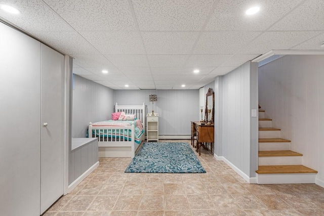 bedroom with recessed lighting, a paneled ceiling, a baseboard heating unit, and baseboards