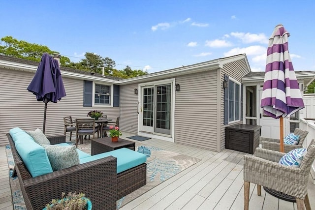 deck featuring outdoor dining area and outdoor lounge area