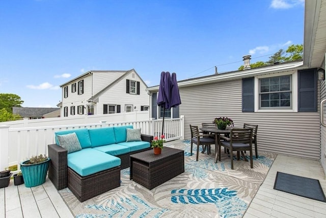 wooden terrace with outdoor lounge area, outdoor dining space, and fence